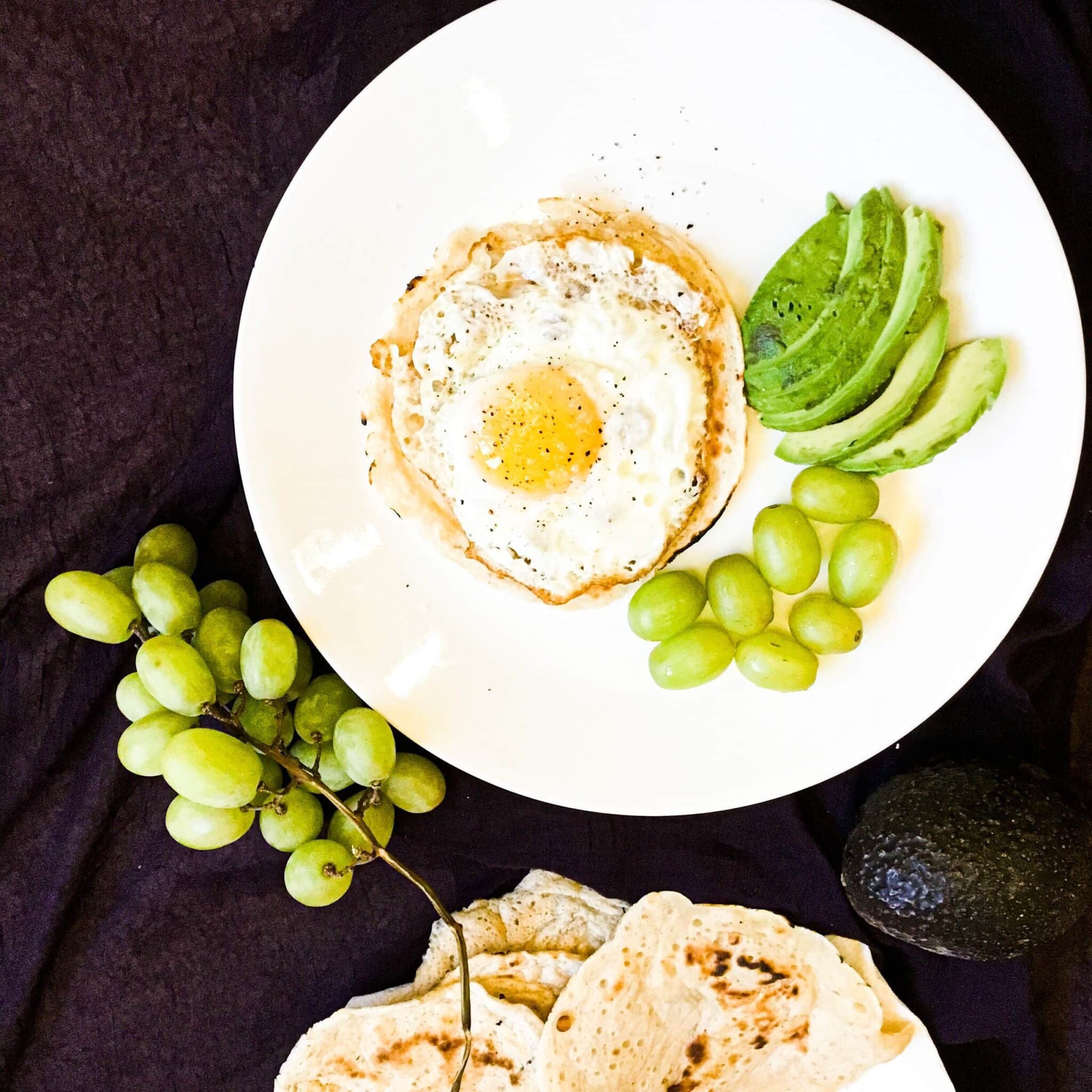 sourdough starter tortillas served with egg and avocado on a plate