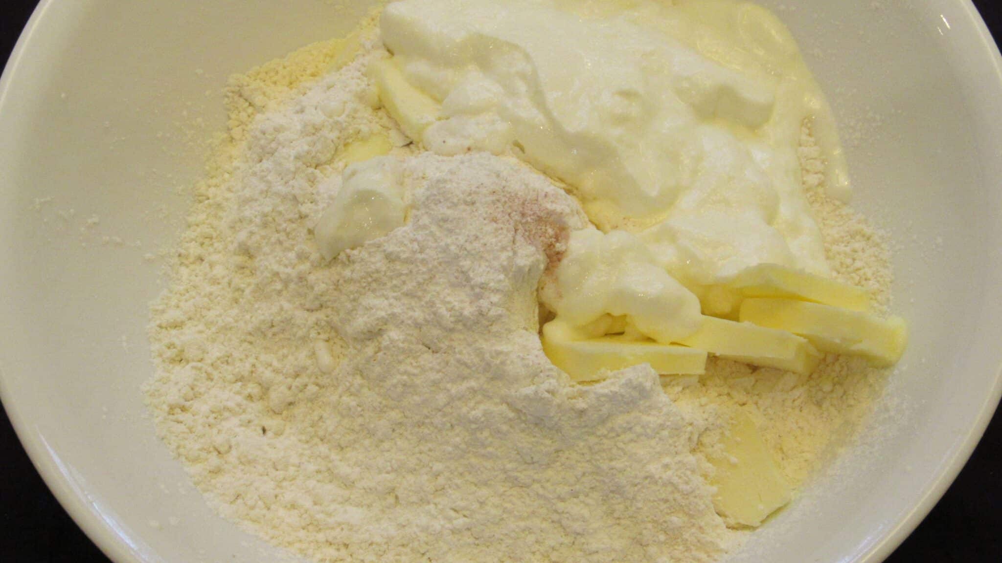 Ingredients for the yogurt biscuits on a white bowl.