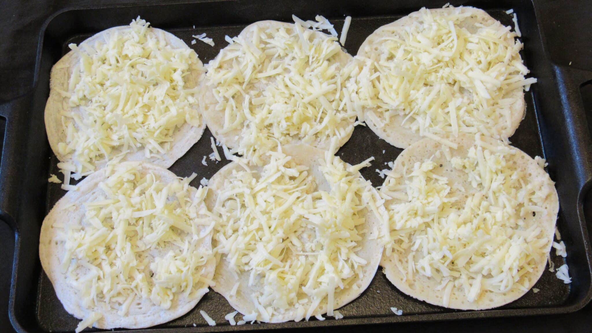layer of cheese on top of sourdough starter tortillas