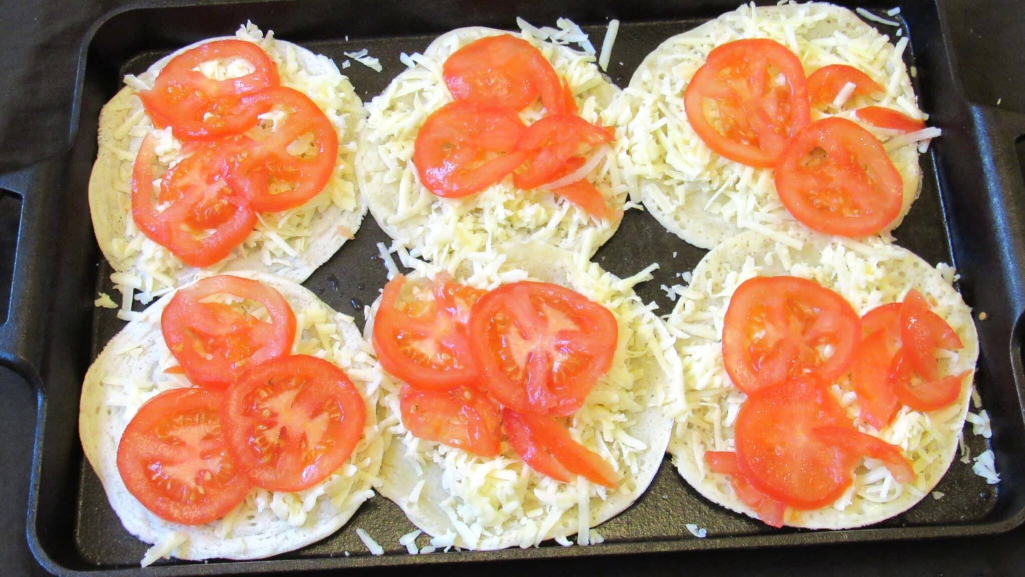 layer of diced tomatoes on top of cheese