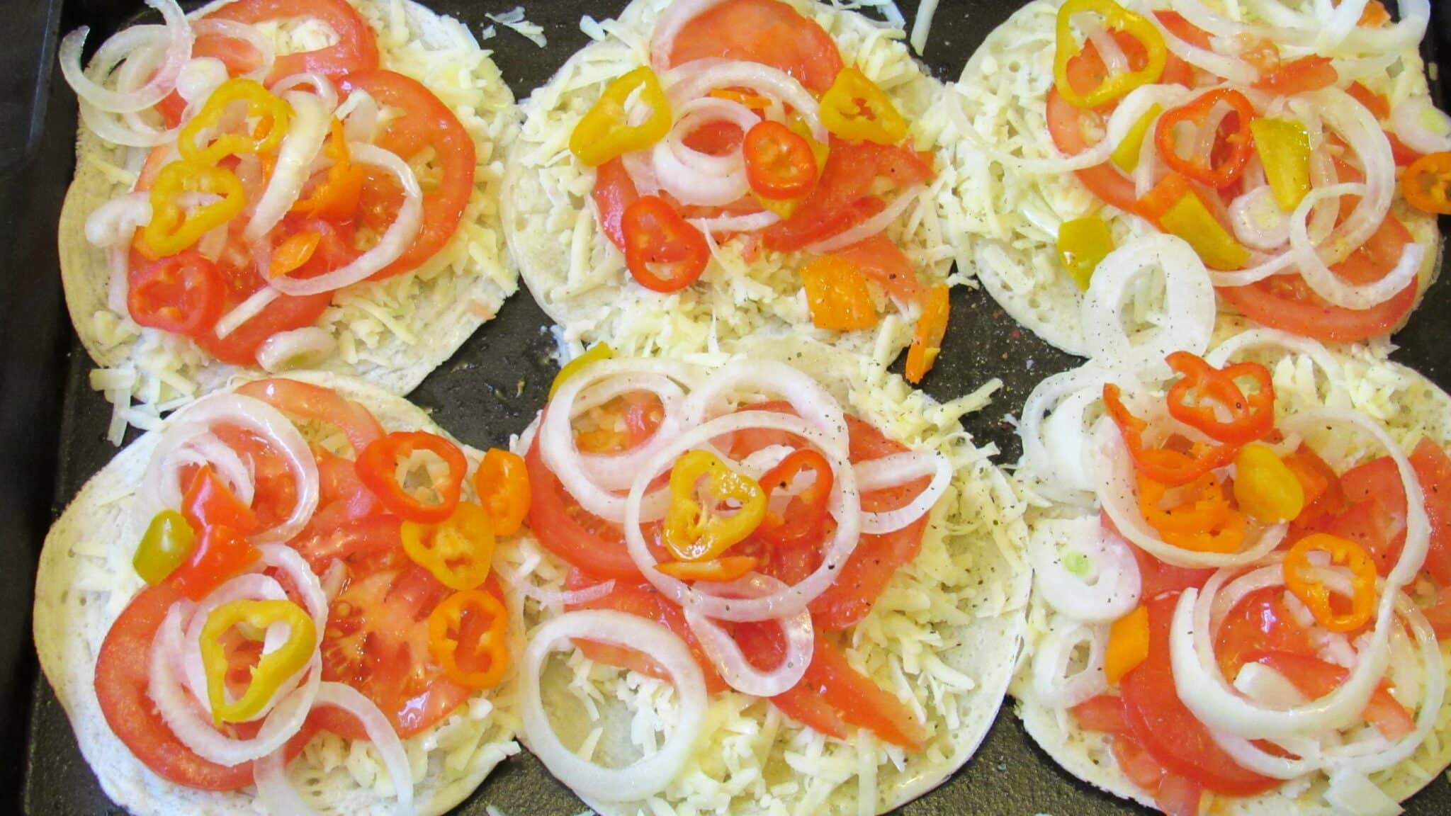 layer of onions and mini sweet peppers on top of tomatoes.