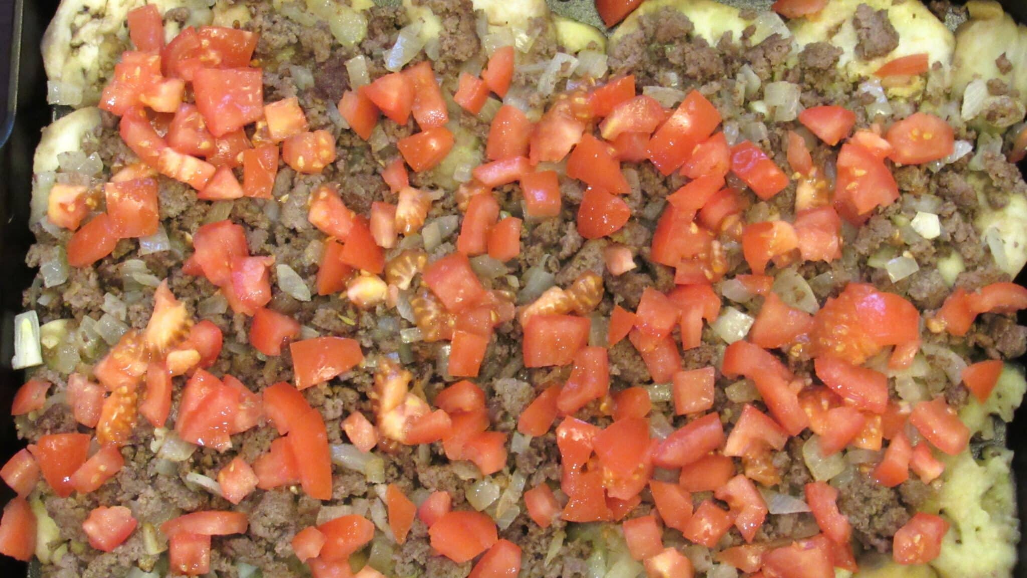 Ground beef eggplant pizza casserole assembling process.