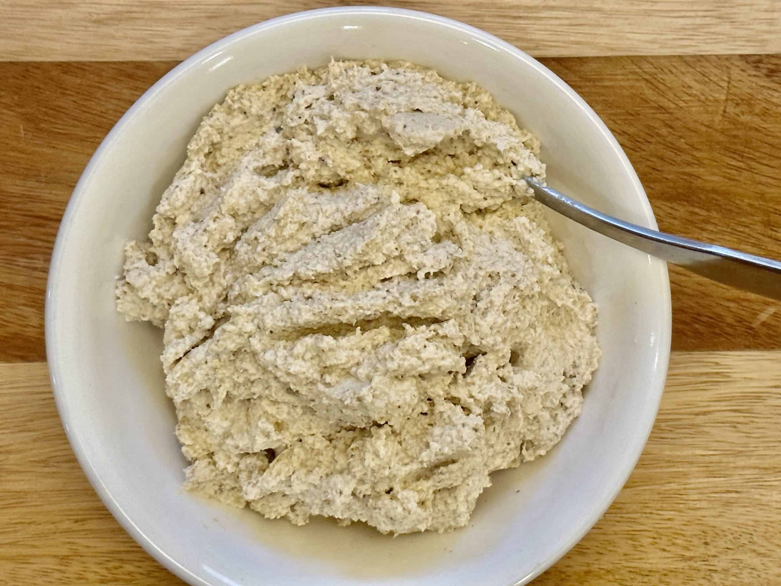 Processed walnut onion paste in a white bowl.