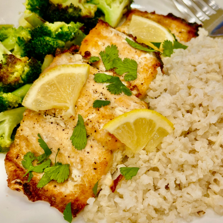 Baked frozen salmon served with rice and broccoli