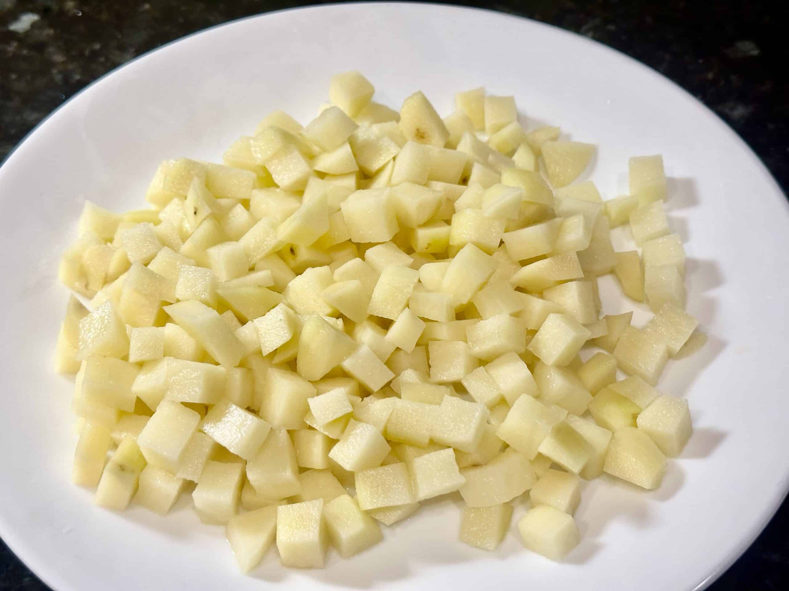 Diced potatoes on a white plate.