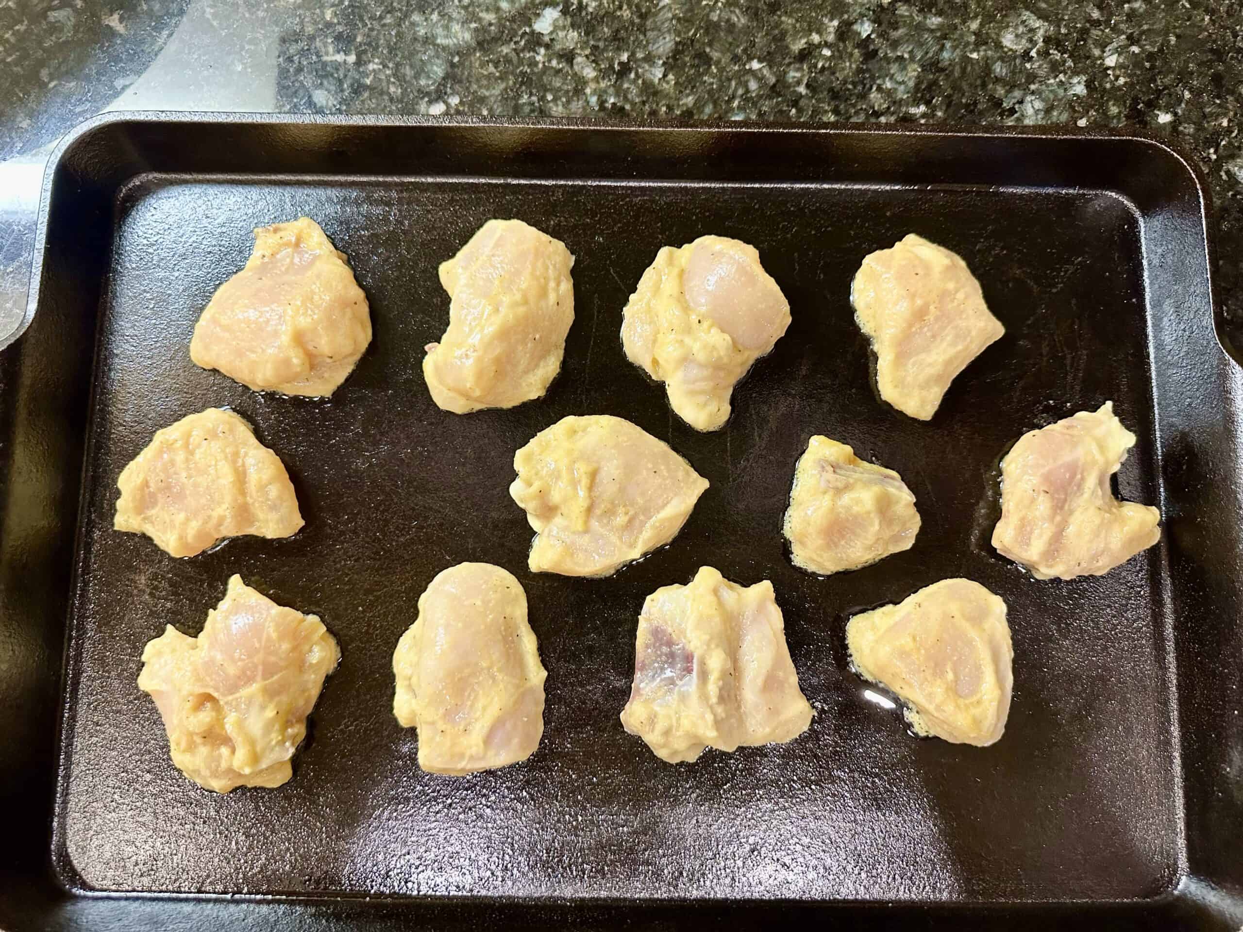 Chicken breast on a hot cast-iron sheet pan.