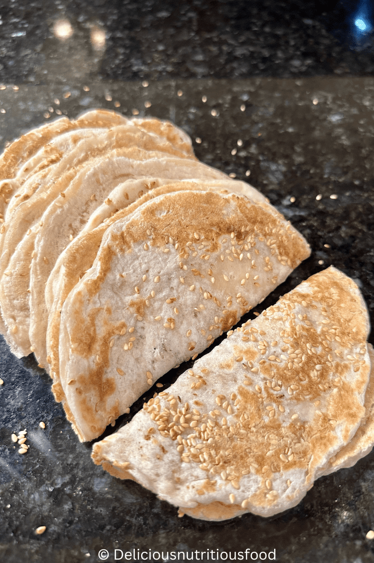 8 quick sourdough discard naan bread/ tortillas (No yogurt wraps) are folded and served.