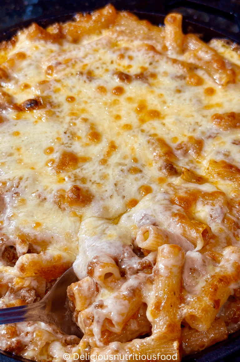 Rigatoni al forno is cooked and served. a close up shot of spooning it out.