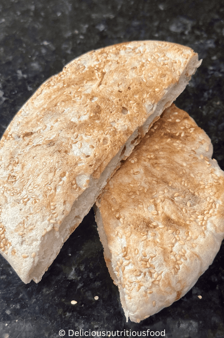 Easy sourdough discard flatbread is sliced in 2 pieces and served.