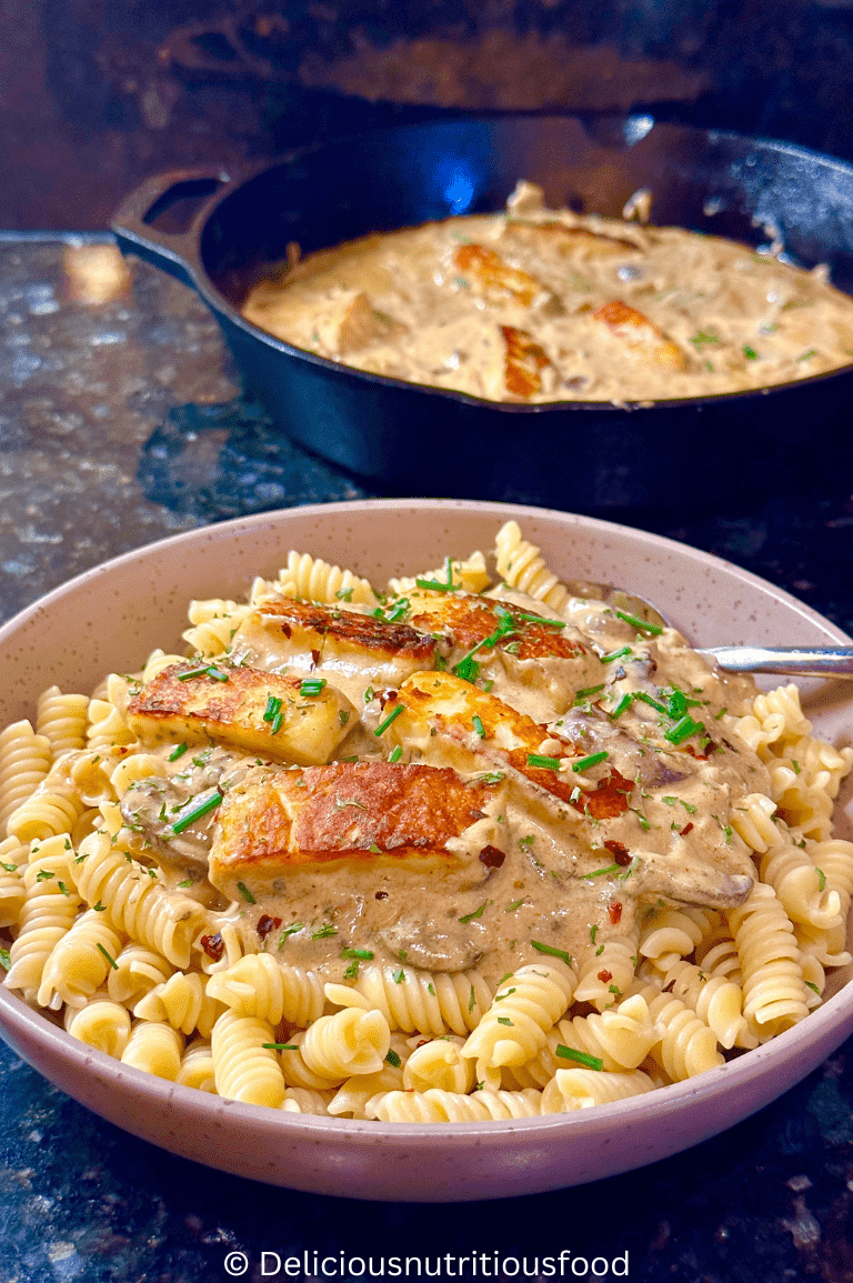 Halloumi Stroganoff is served with pasta on a plate.