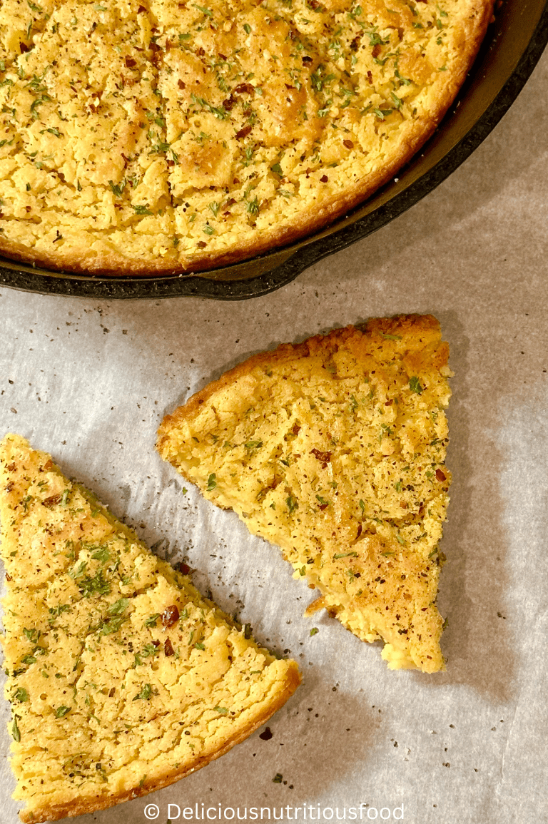 farinata di ceci recipe -Italian chickpea pancake is sliced and garnished with red pepper flake, parsley and fresh black pepper. Two slices are in close up shots.