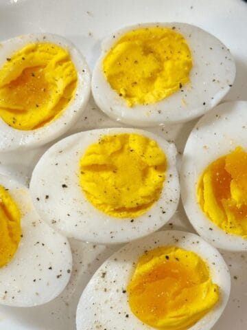 Slices of duck eggs on a white plate.